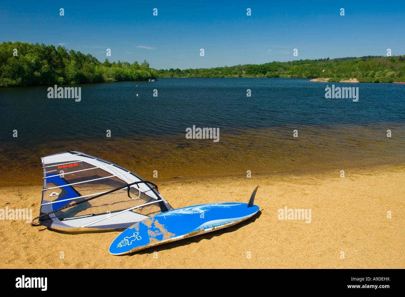 Windsurfing board lying on the beach of Horseshoe Lake in Trilakes