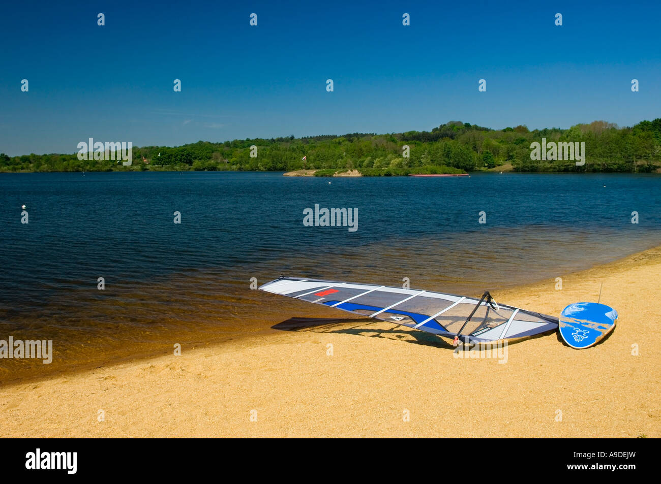 Windsurfing board lying on the beach of Horseshoe Lake in Trilakes