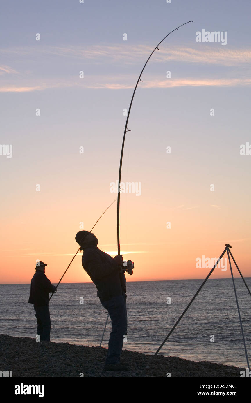 Sea fisherman reeling in a fish from weybourne beach at dusk North norfolk Stock Photo - Alamy Sea fisherman reeling in a fish from weybourne beach at dusk North norfolk Stock Photo - Alamy