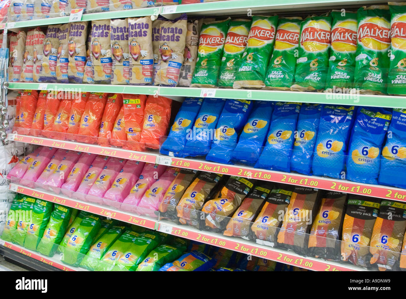 Bags of crisps and potato snacks on a supermarket shelf Stock Photo