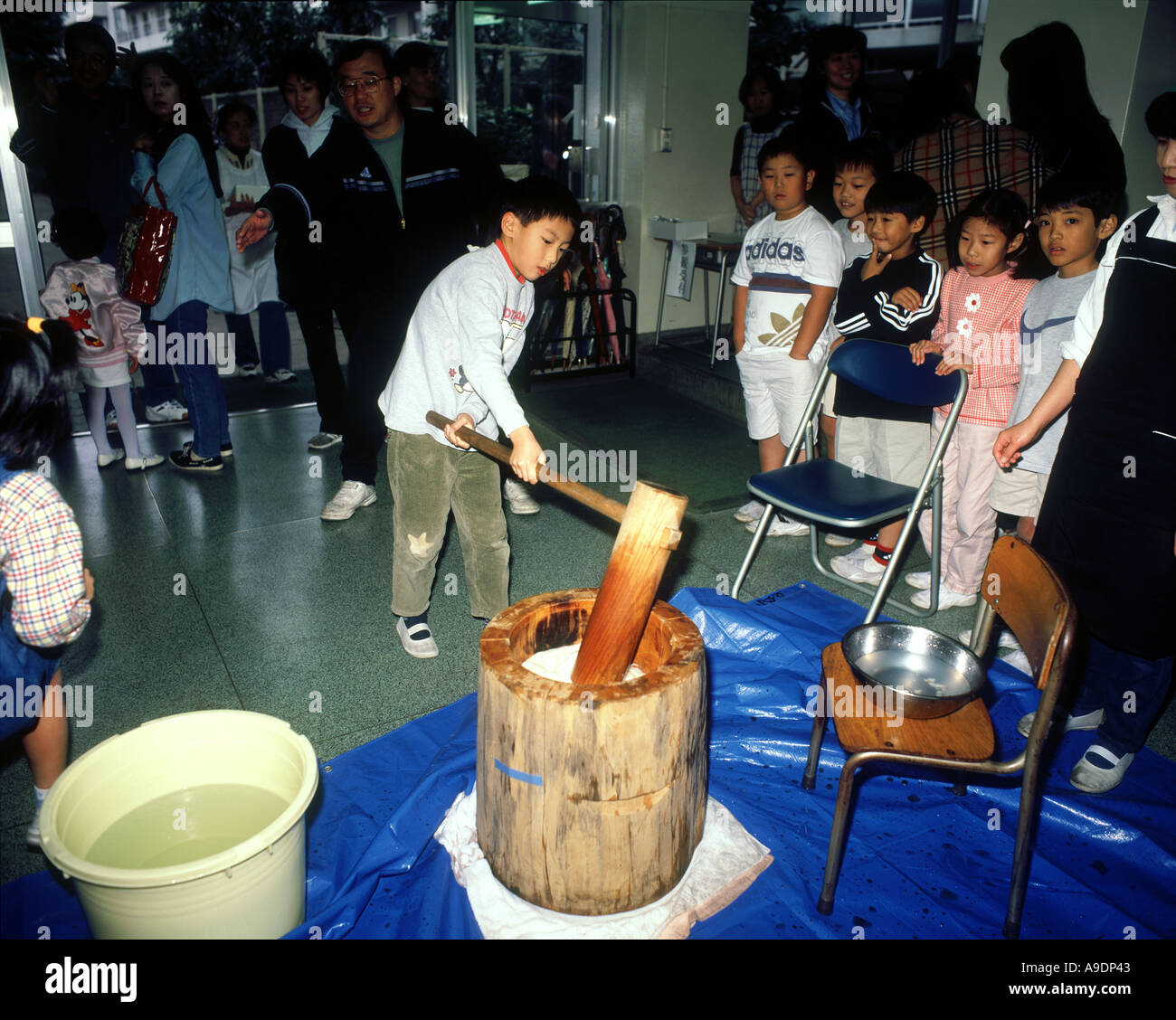Children pounding rice for making rice cake Tokyo Japan Stock Photo