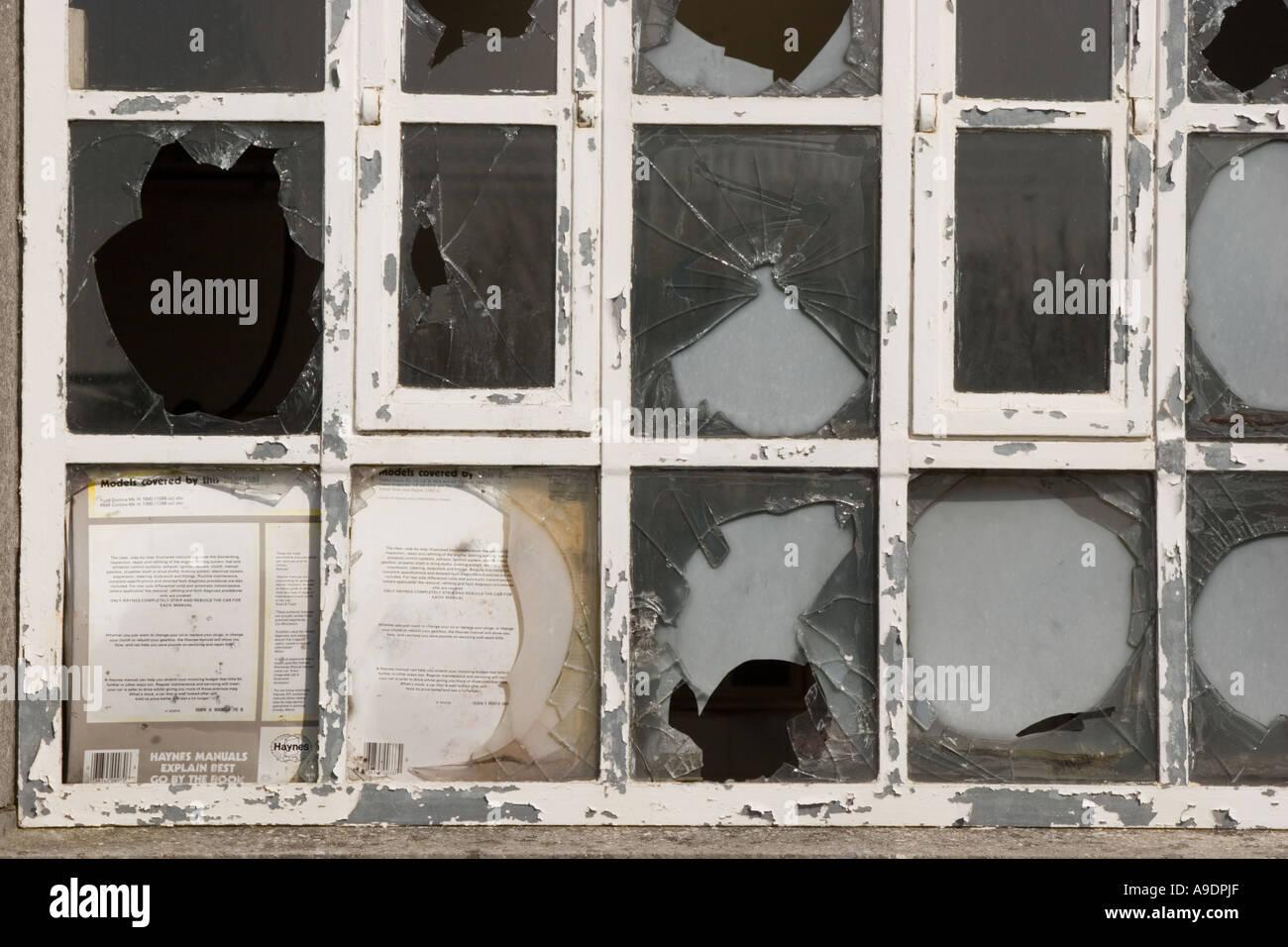 Broken windows in an empty and derelict office block Stock Photo