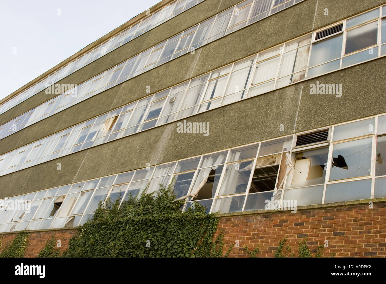Broken windows in an empty and derelict office block, building on a ...