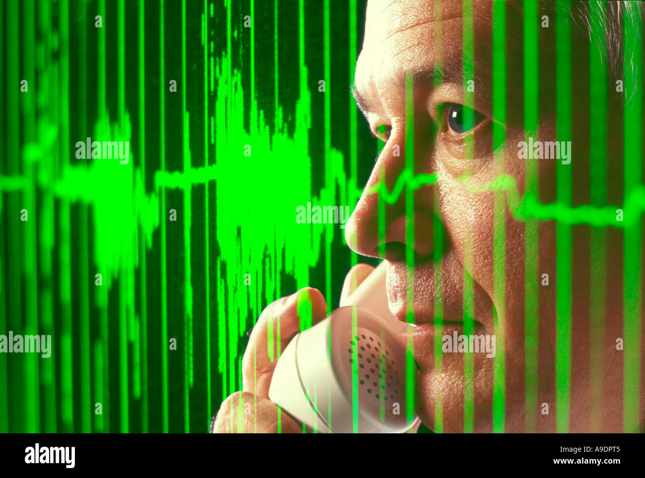 business executive on phone to a client with computer generated audio signal graphic on screen Stock Photo
