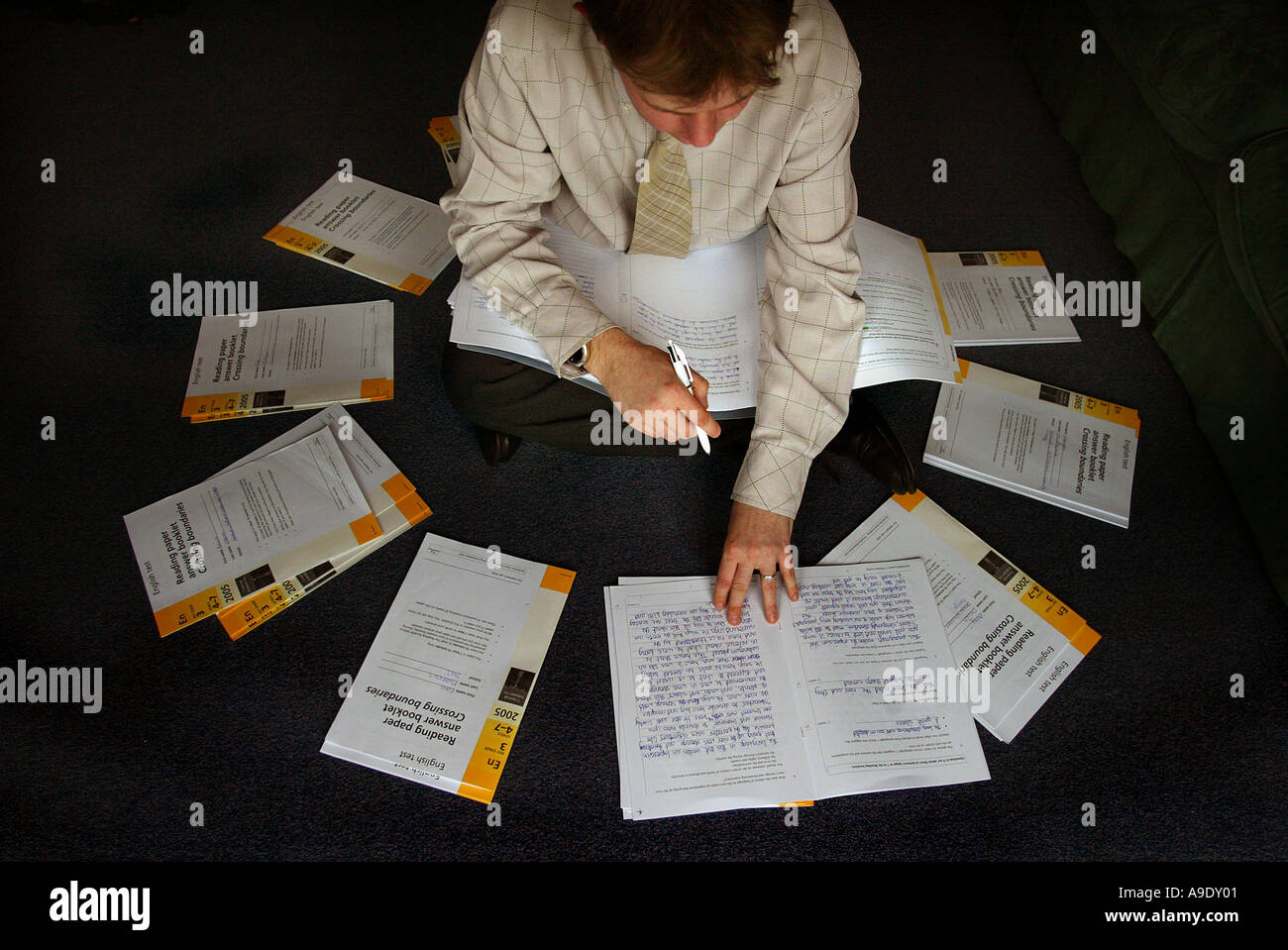 A teacher marking Key Stage 3 English papers. Stock Photo