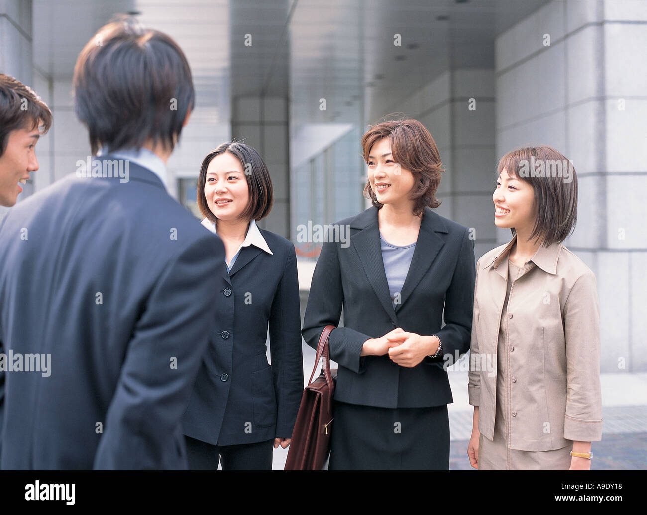 Business people talking outdoors Stock Photo - Alamy