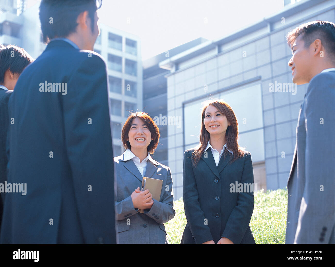 Business people talking outdoors Stock Photo - Alamy