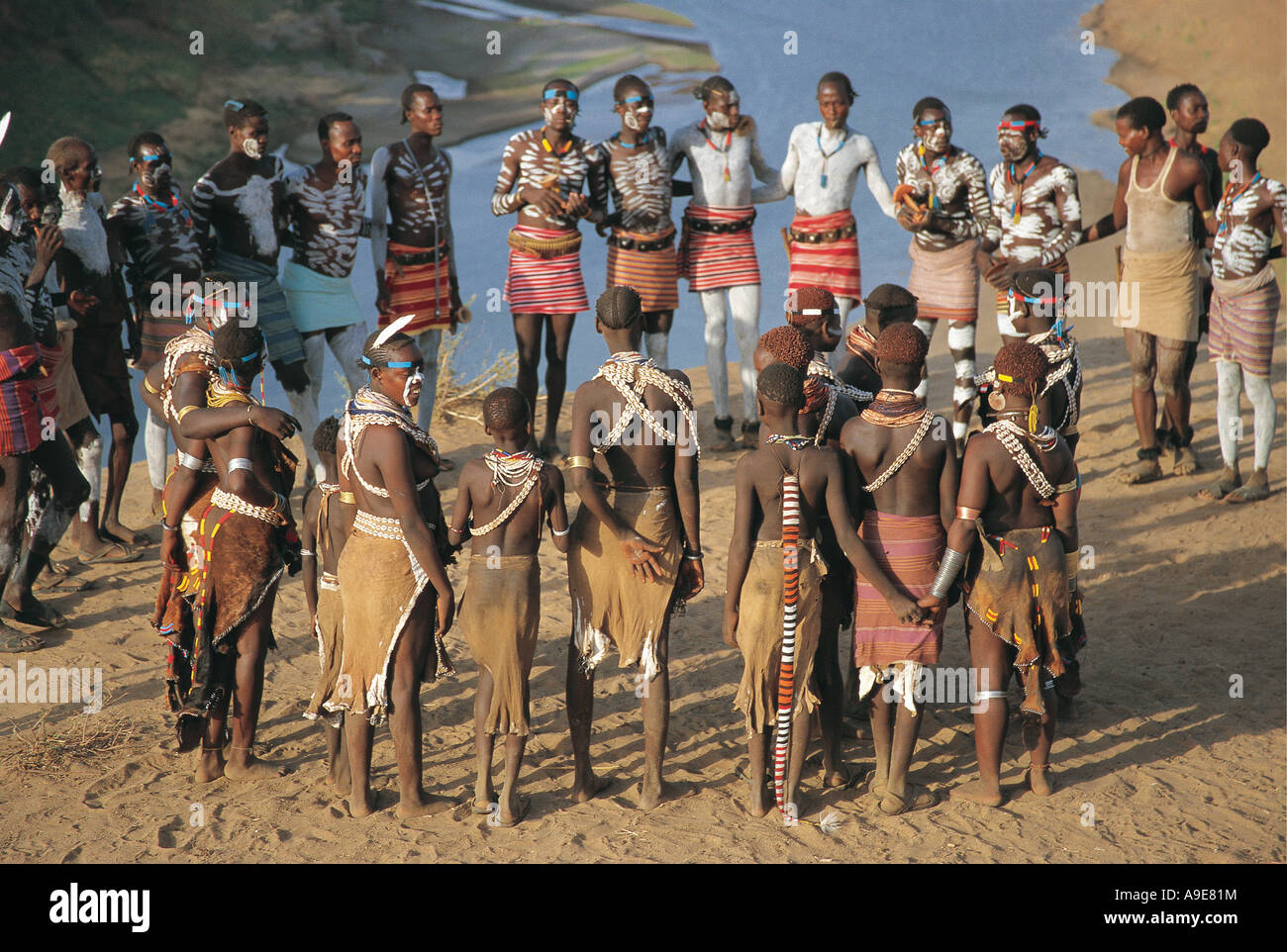 A group of young Karo dancers with hand painted bodies Banks of Omo river Murulle Ethiopia Stock Photo