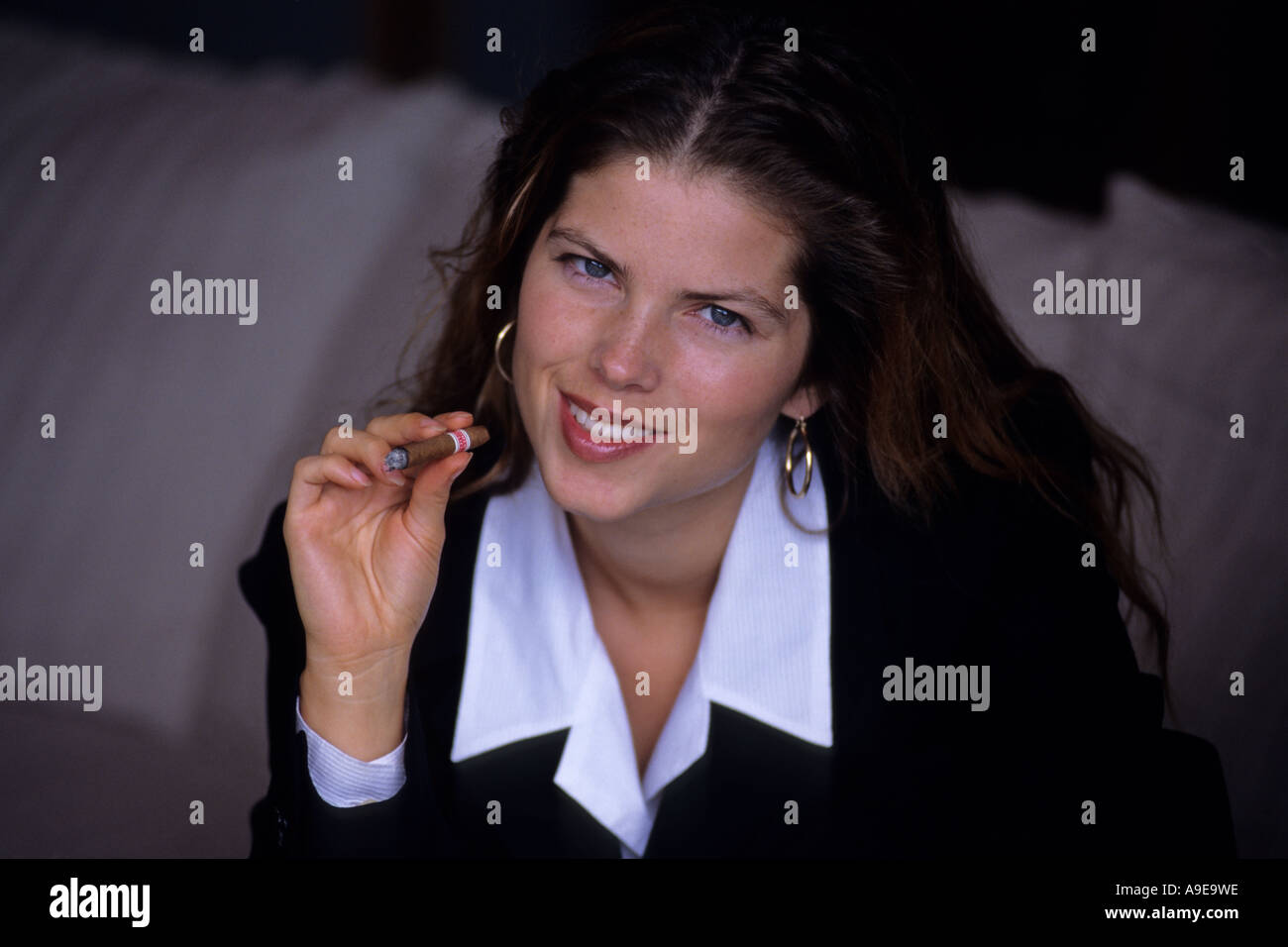 Woman smoking cigar Stock Photo