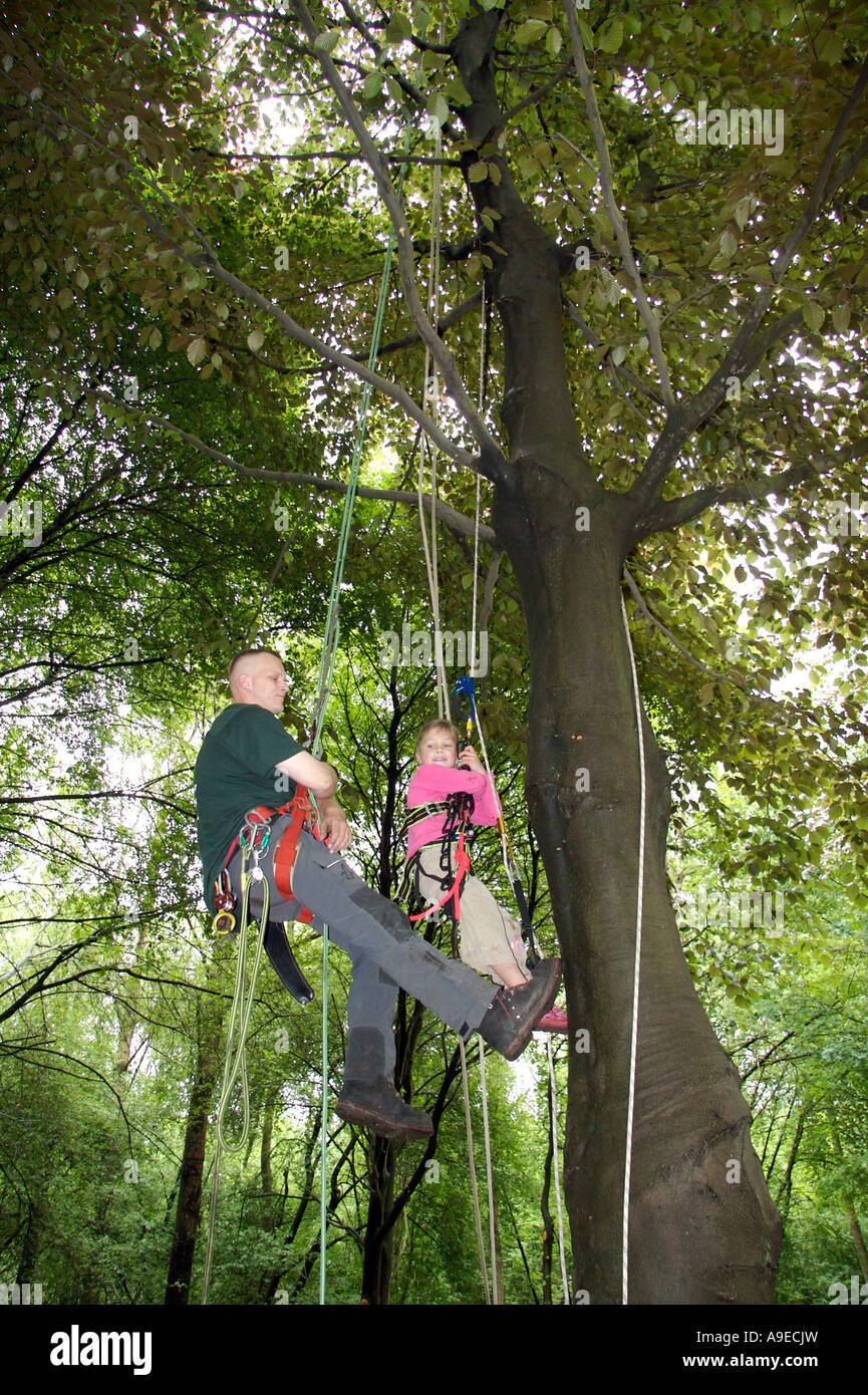 Tree climbing teacher and girl Stock Photo Alamy