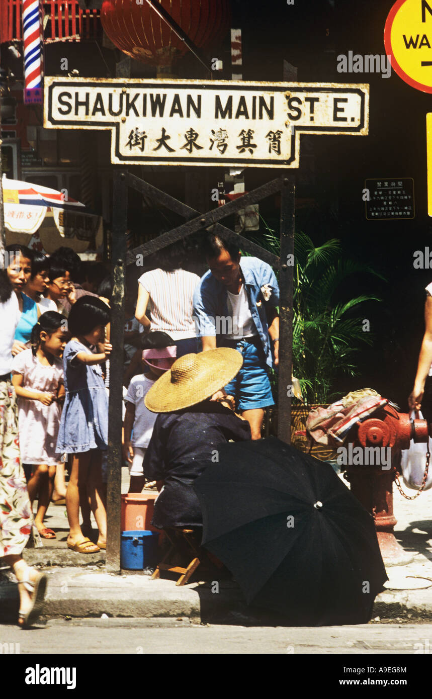 China, Hongkong. Street seller in Shaukiwan Main St. E.The name means pail along the shore. See larger caption Stock Photo