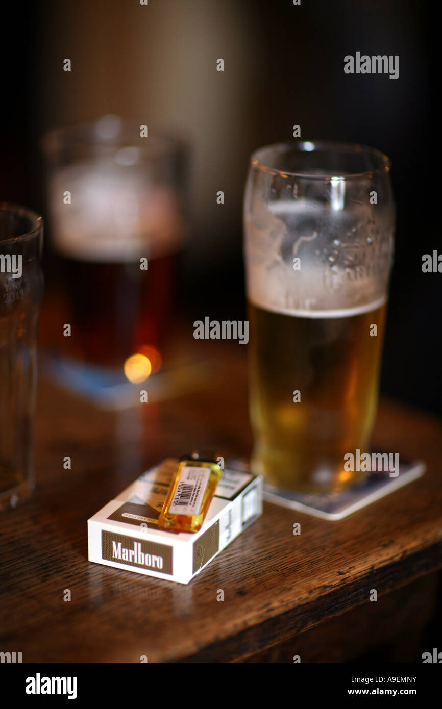A pack of cigarettes and a pint in an English pub Stock Photo Alamy