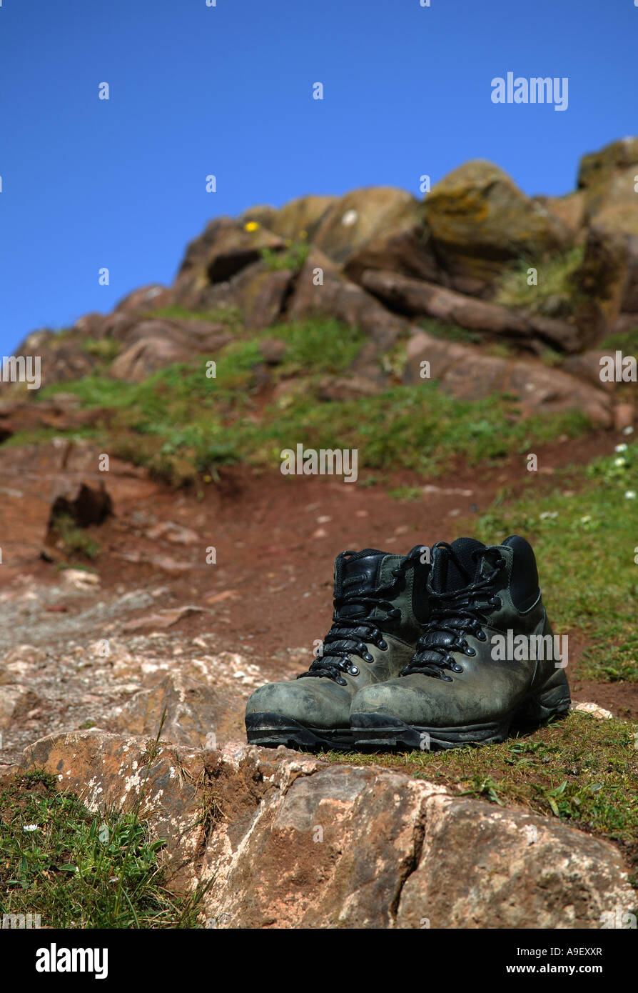 Pair of grey walking boots sitting on rocks, Edinburgh Scotland Europe