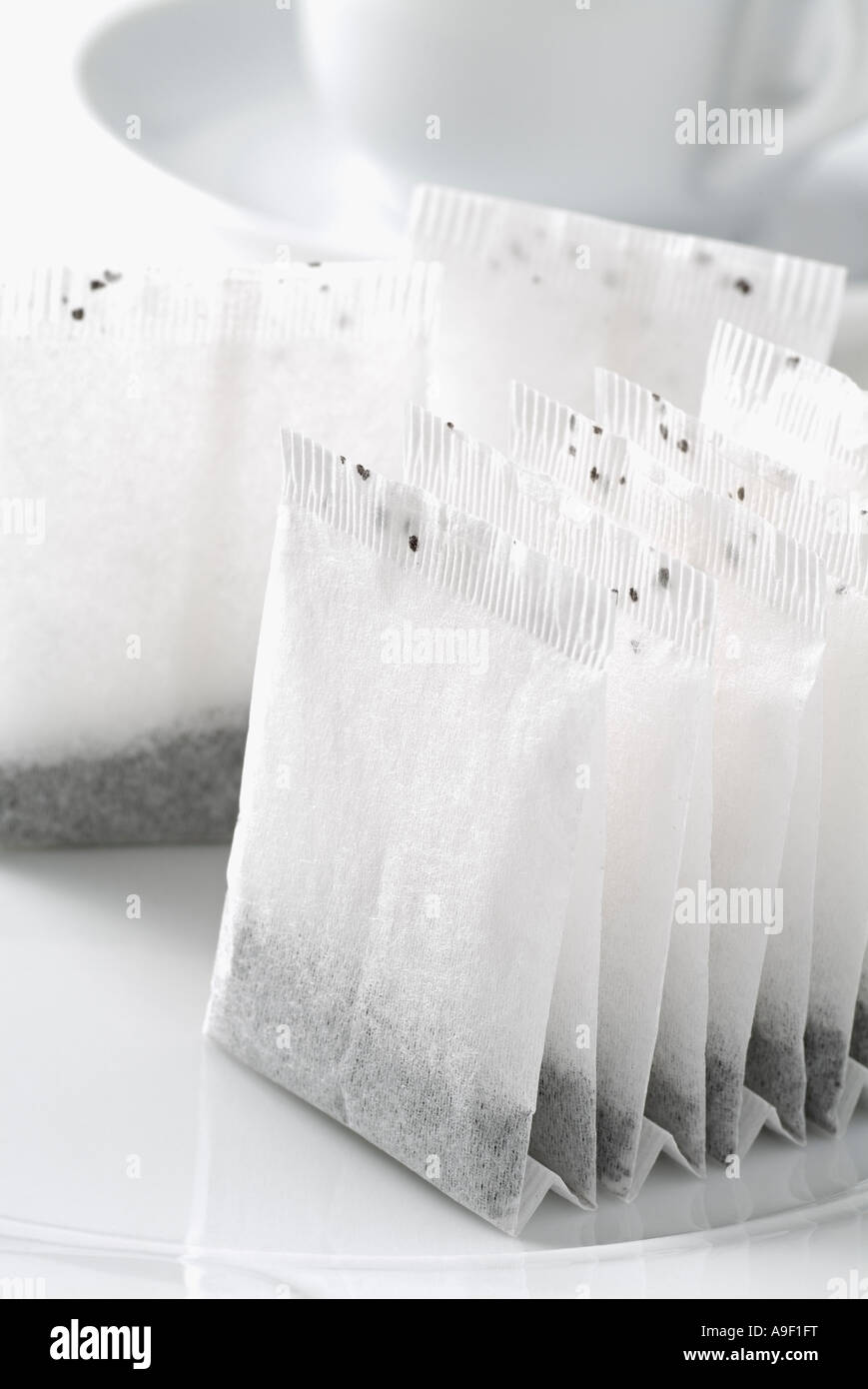Teabags with a Tea Cup and Saucer in the Background Stock Photo