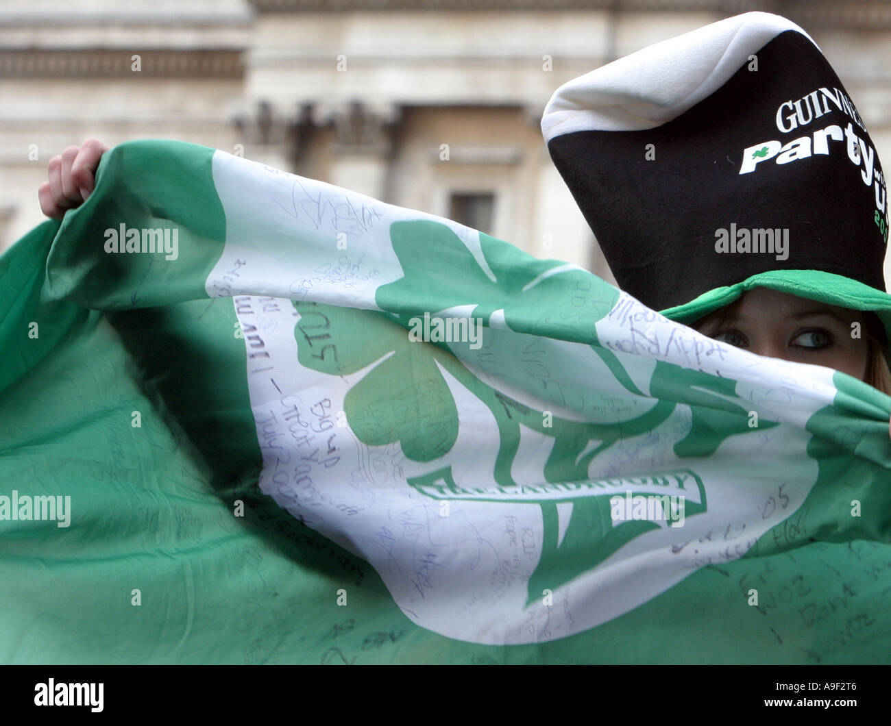 A woman waves a flag at Trafalgar Square during St Patrick´s Day celebrations, London, 12 March 2006. Stock Photo