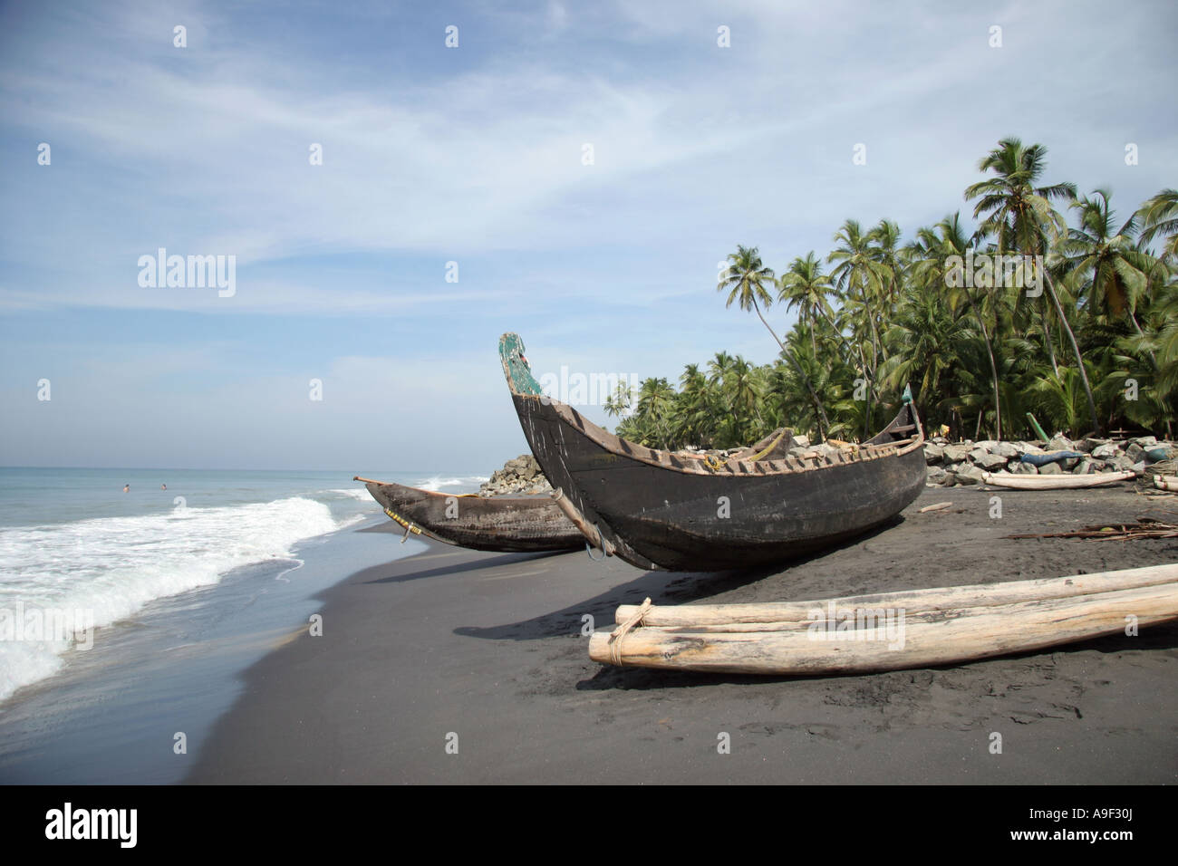 Traditional rustic stitched wooden fishing boats on the beach in Varkala, Kerala, South India Stock Photo