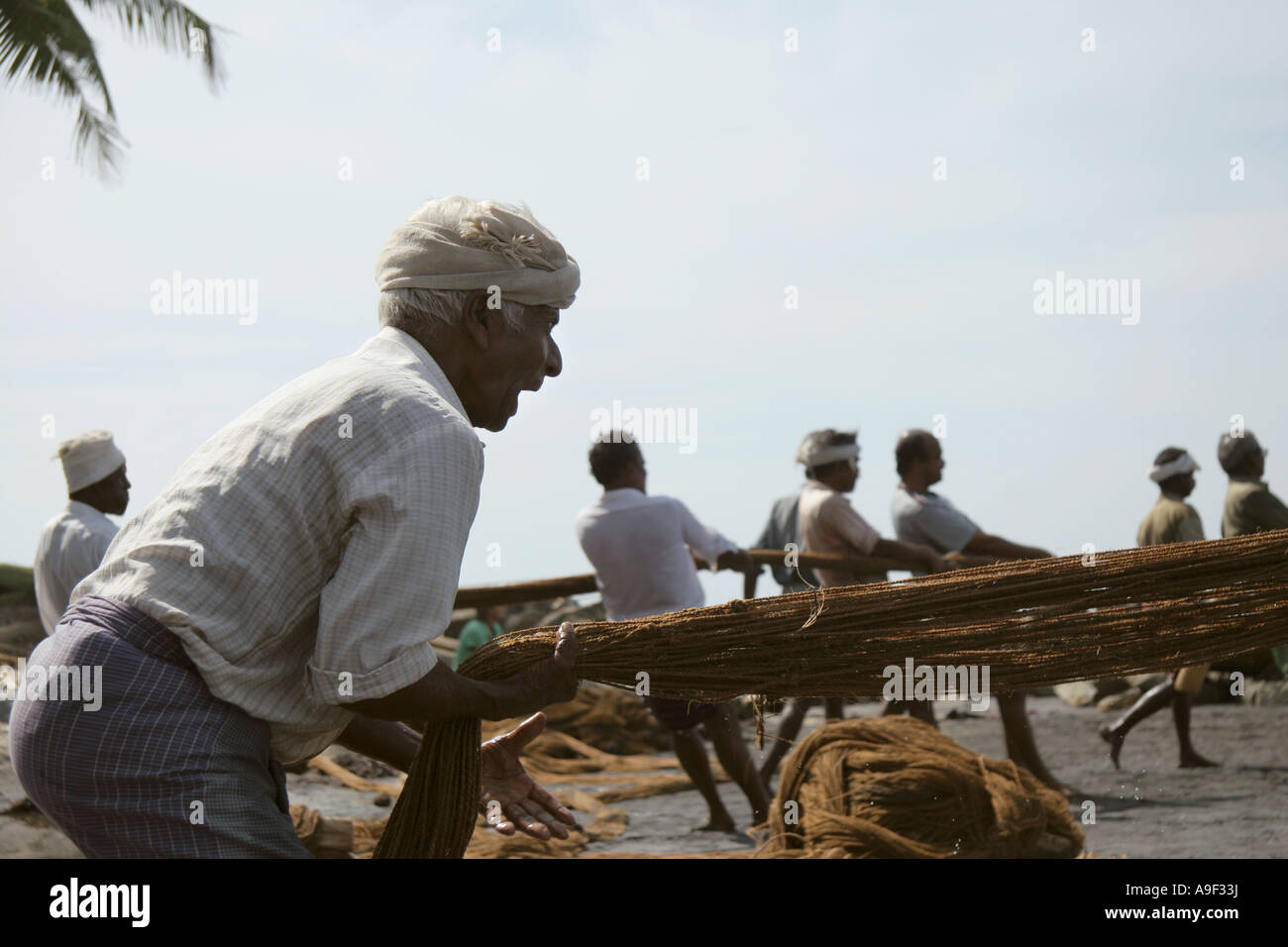Fishermen haul in their nets on the beach in Varkala, Kerala, South India Stock Photo