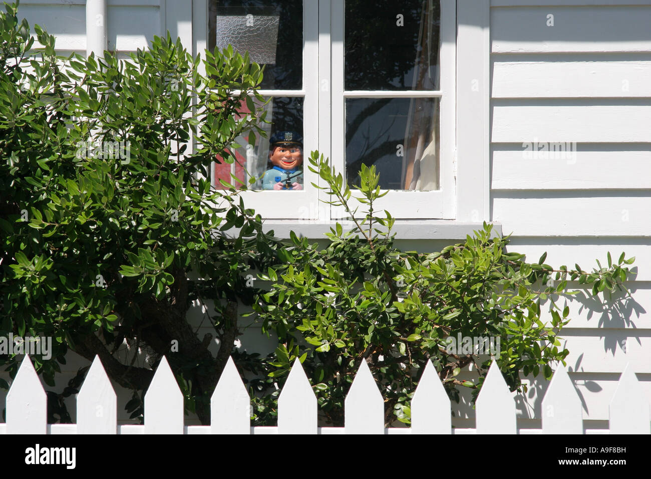 A ceramic officer sits in the window of the police station in Russell, The Bay of Islands in the North Island, New Zealand Stock Photo