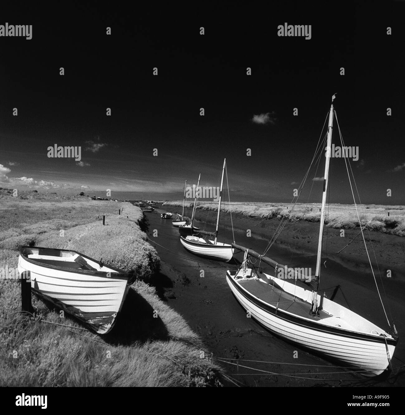 Dinghies moored in the creeks, in the coastal resort of North Norfolk