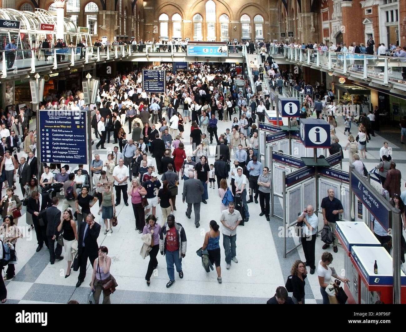 London travel problems in City of London UK as crowd of people at Liverpool street train station wait on the main concourse for transport changes Stock Photo