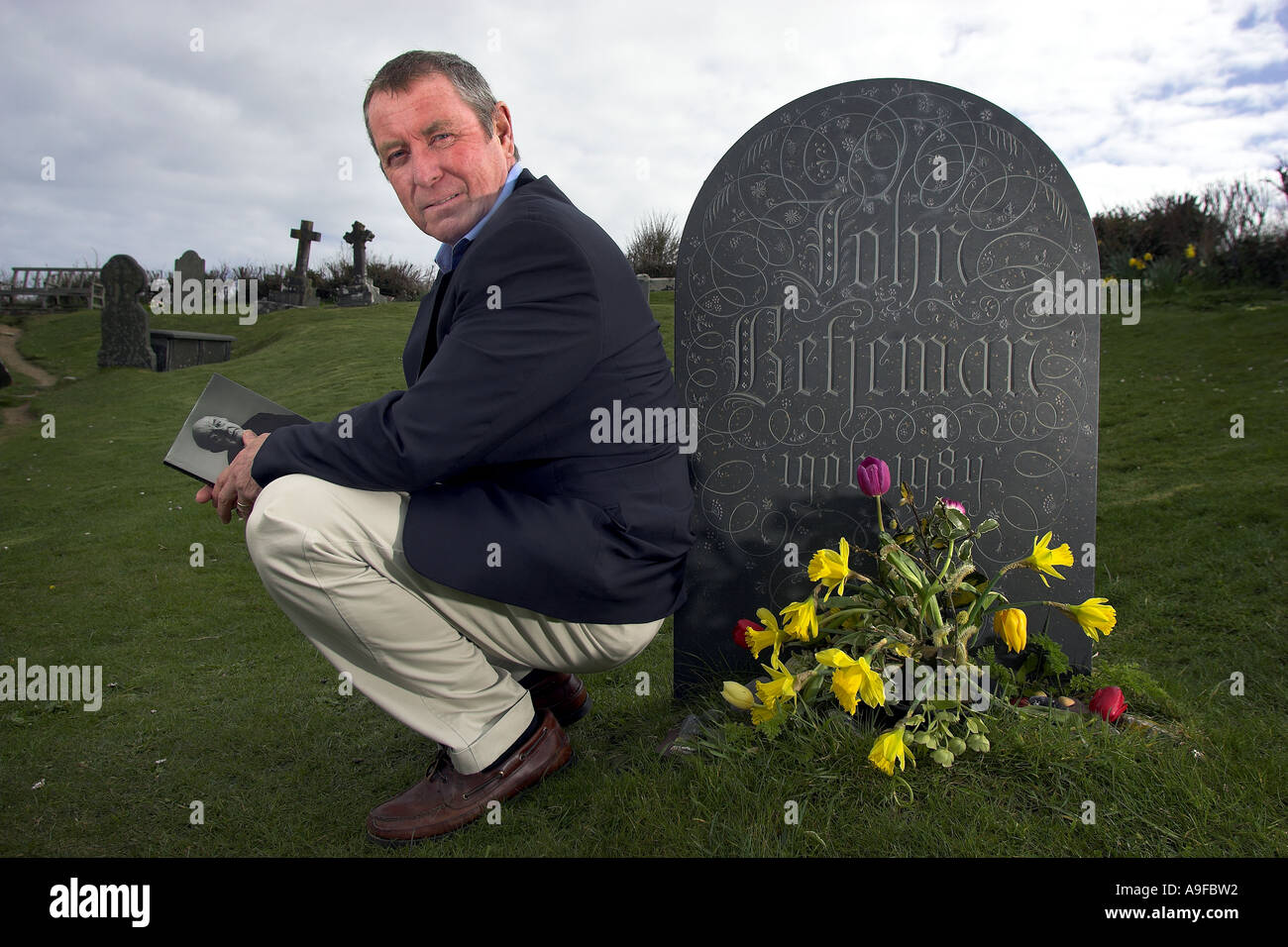 Actor John Nettles at the grave of John Betjeman at St Enodoc's Church