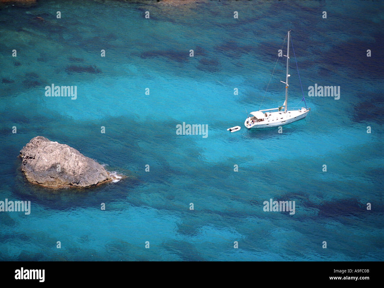 A yacht in the clear blue mediterranean ocean off the north coast of Cap de Formentor in Majorca Stock Photo