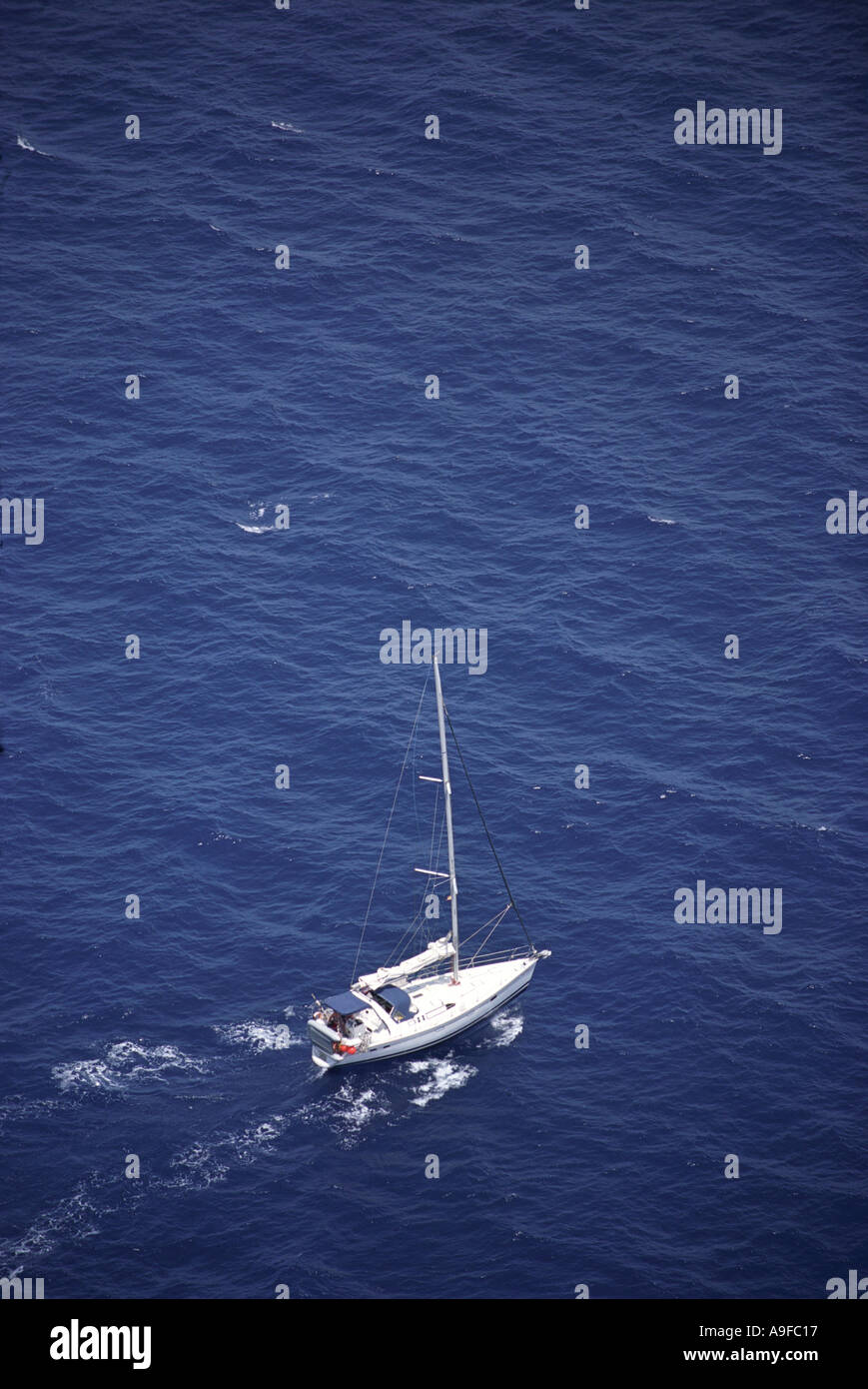 A yacht in the dark blue mediterranean sea off the north coast of Cap de Formentor in Majorca Stock Photo