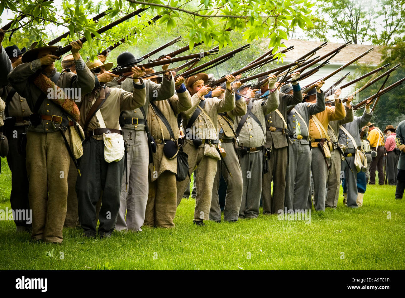 Civil war reenactors pointing their guns and shooting Stock Photo