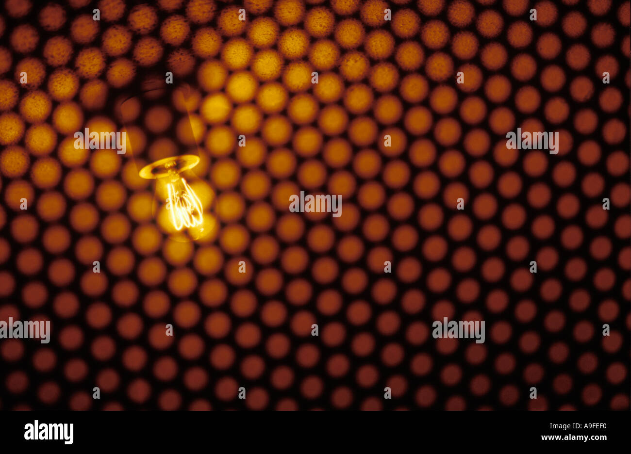 A light bulb behind a raster Stock Photo