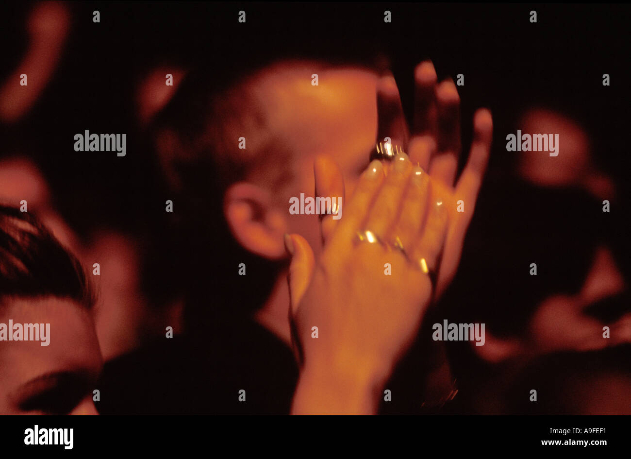 Woman clapping her hands on a concert. Stock Photo