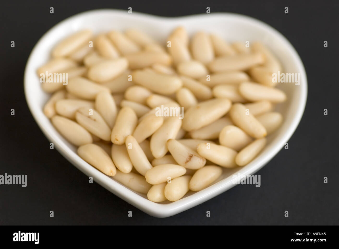 Organic pinenuts in a bowl Stock Photo