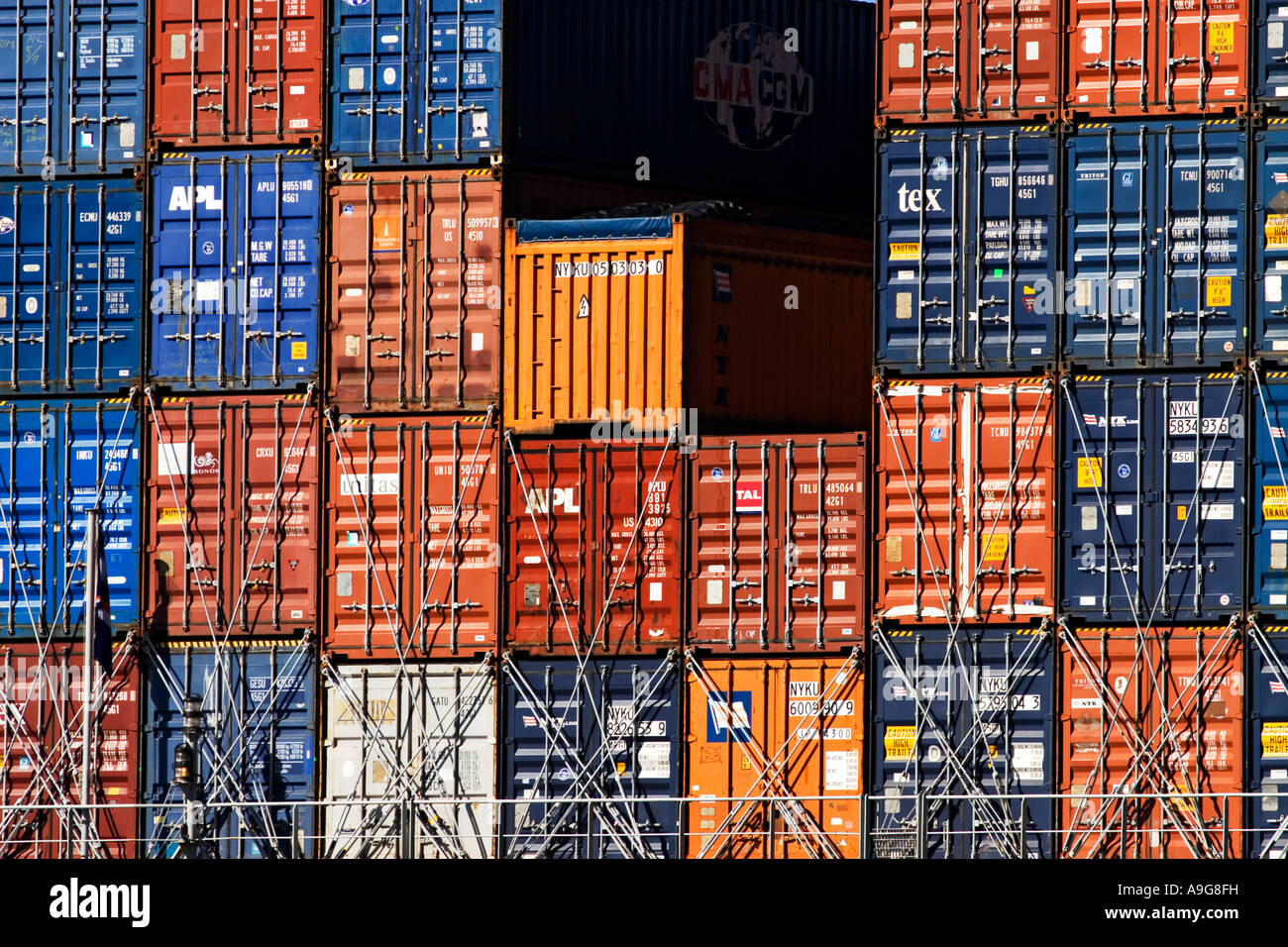 Shipping Industry / Shipping containers stacked on the deck of a ship