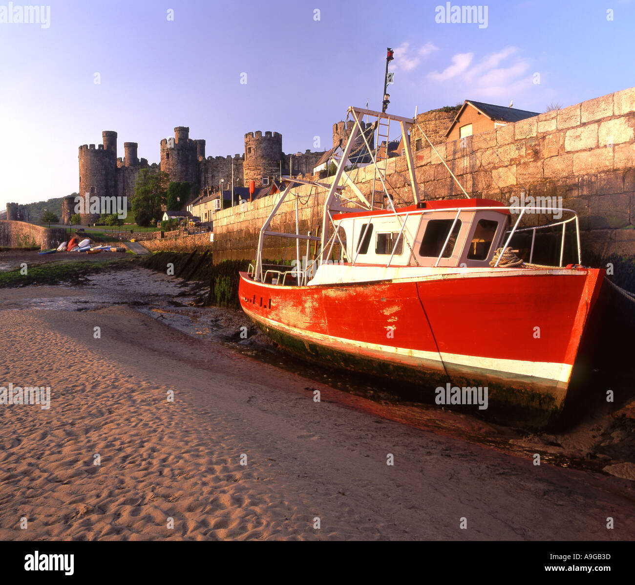 Red Fishing Boat Below Conwy Castle North Wales UK Stock Photo