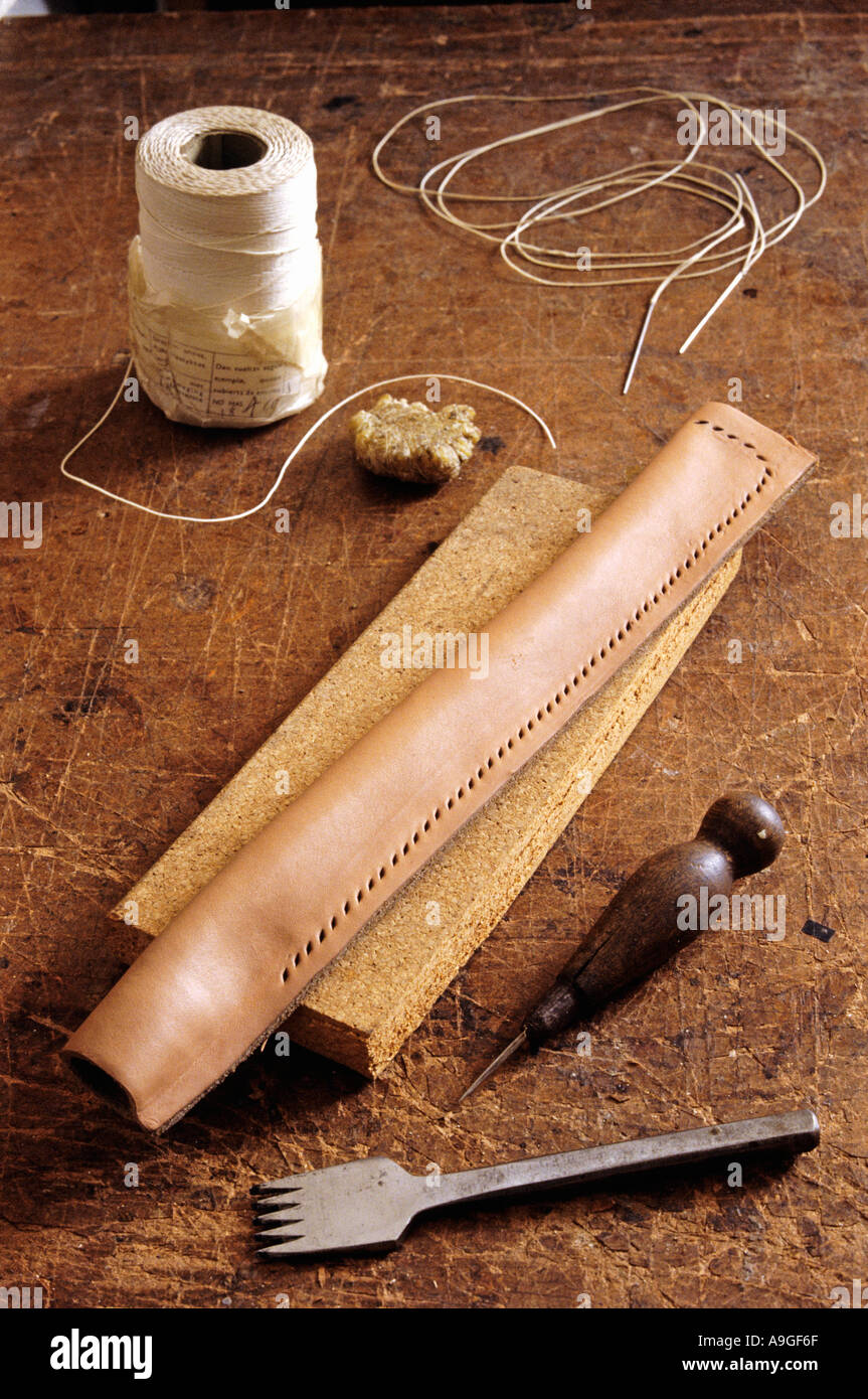 Punching the holes in the leather Stock Photo Alamy