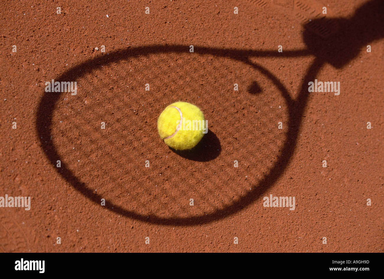 tennis ball, with the shadow of a racket. Stock Photo