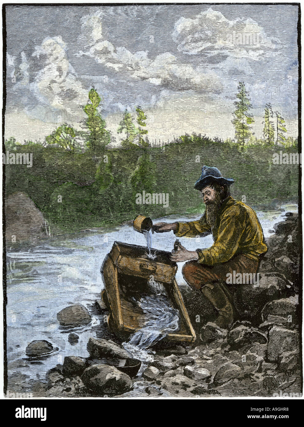 Gold Rush prospector washing pebbles from a stream using a cradle Stock