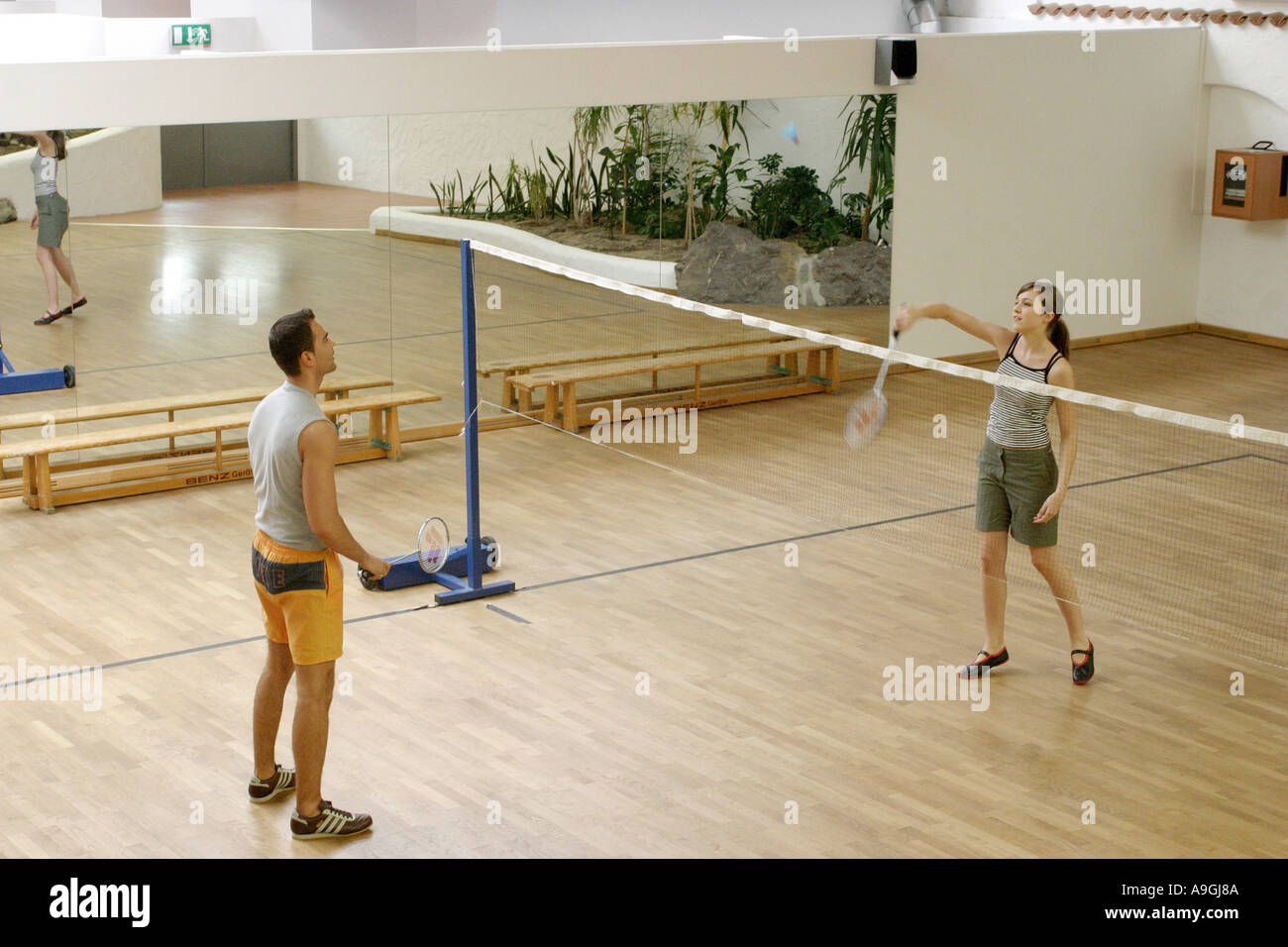 couple playing badminton in a badminton hall. Stock Photo