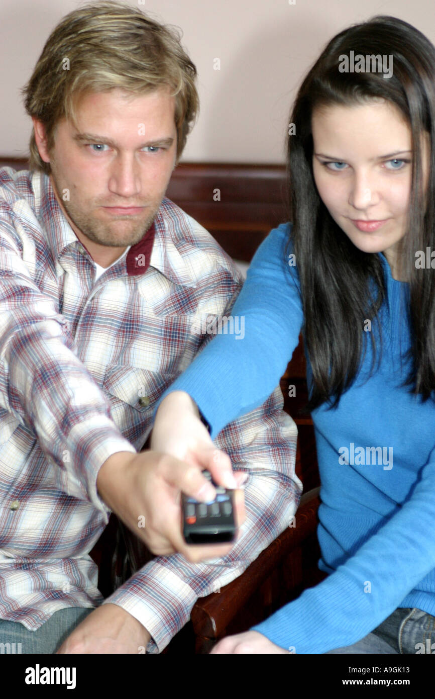 couple fighting over remote control. Stock Photo