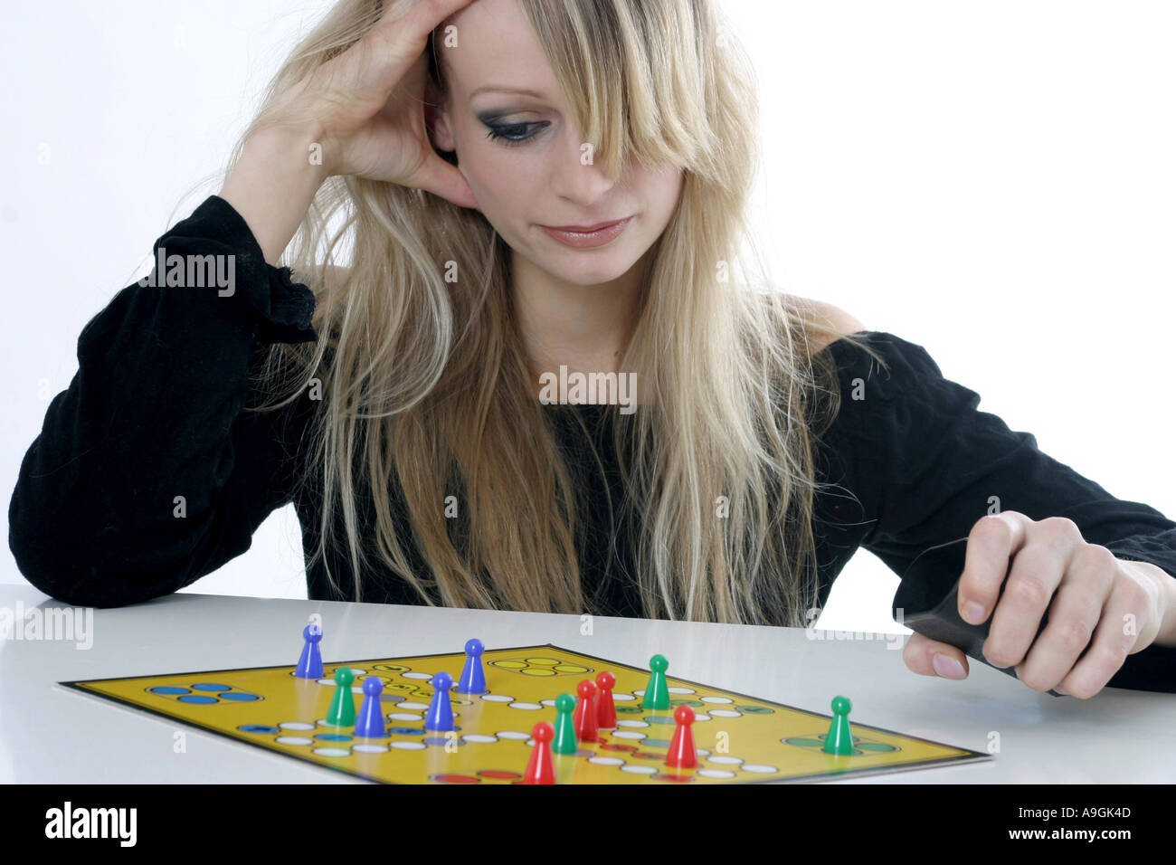 blond woman with Ludo game. Stock Photo