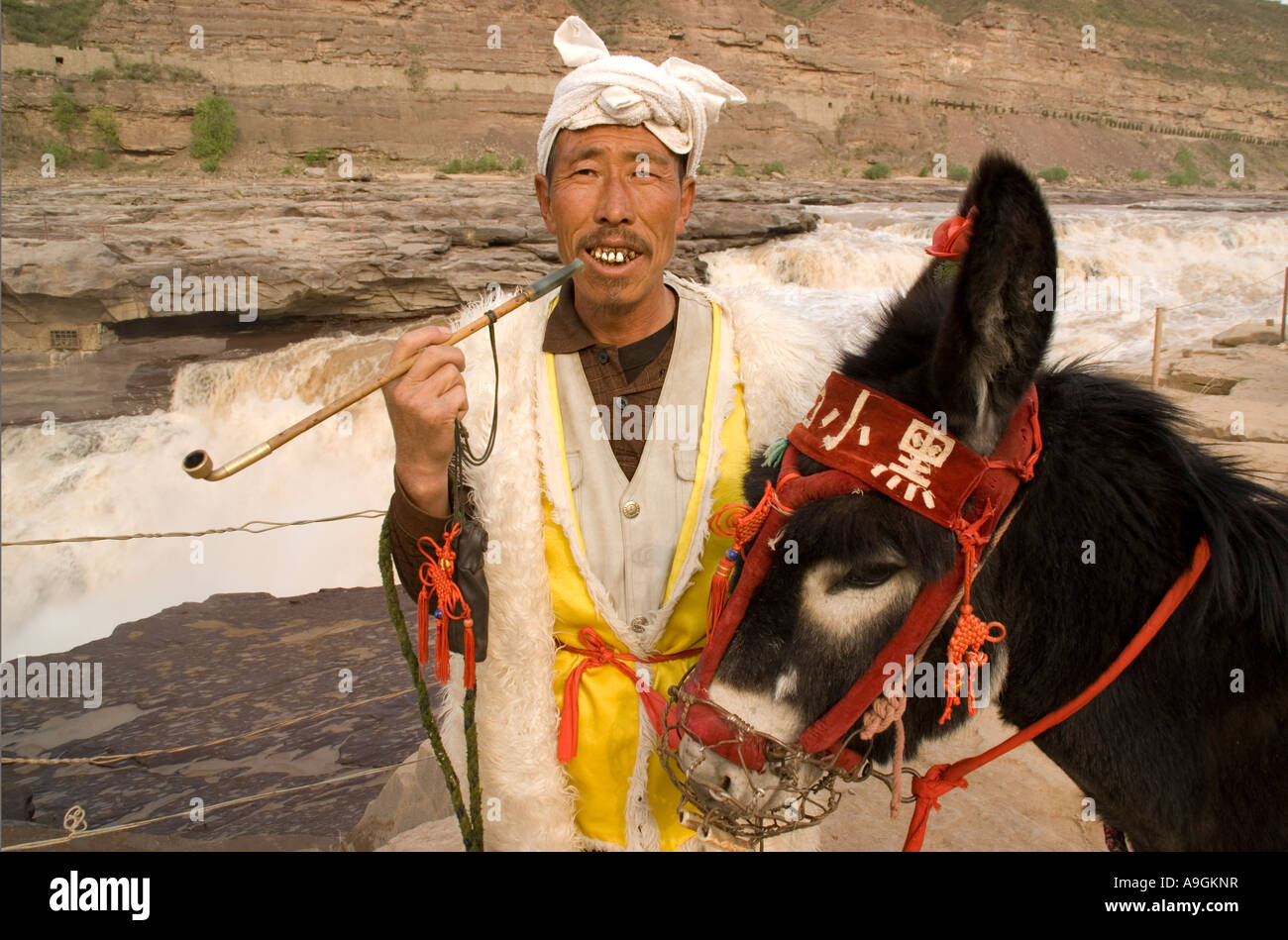 Local Shanxi farmer with his donkey at the Hukou Waterfalls Local Shanxi farmer with his donkey at the Hukou Waterfalls