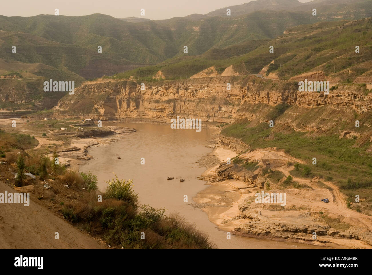 Yellow River (Huang He) down river from Hukou waterfalls on loess plateau Shanxi province with Shaanxi on opposite bank Stock Photo