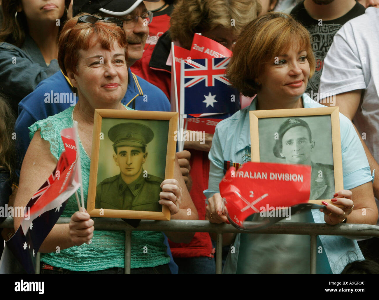 ANZAC day Sydney Australia sisters hold photographs of their father who died during World war 11 Stock Photo