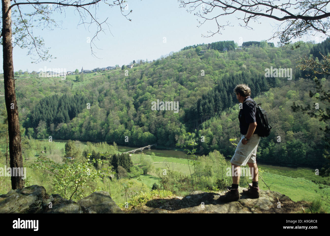 Walker in the Belgian Ardennes overlooking the Semois river and Rochehaut village Ardennes Belgium Stock Photo