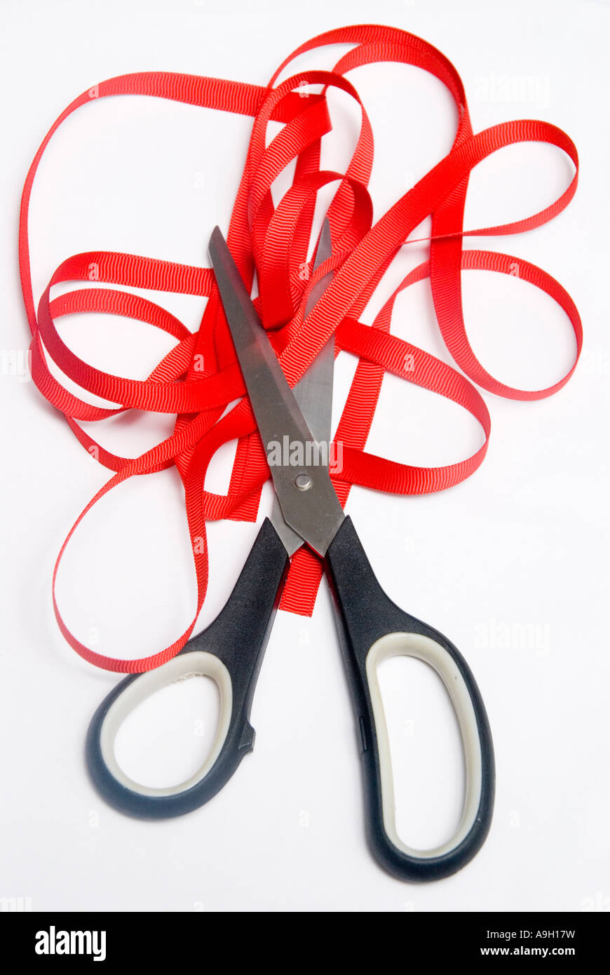 Scissors cutting through red tape Stock Photo Alamy