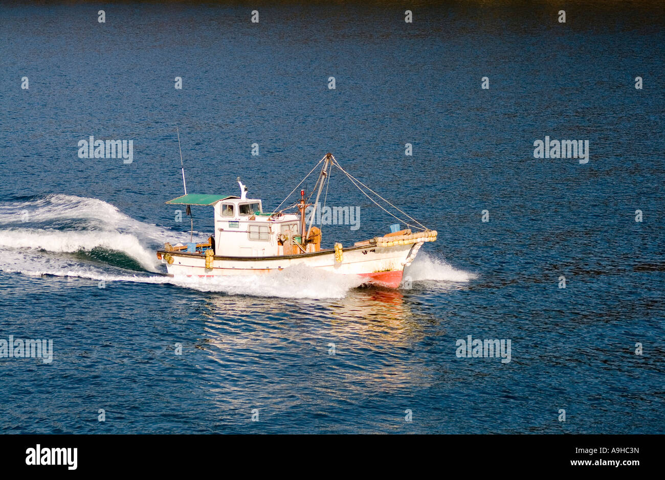 fishing boat returning to the harbor Stock Photo - Alamy