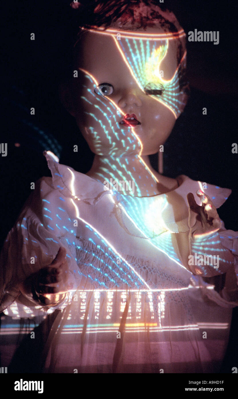 scary doll in the dark with patterned light shining on its face Stock Photo