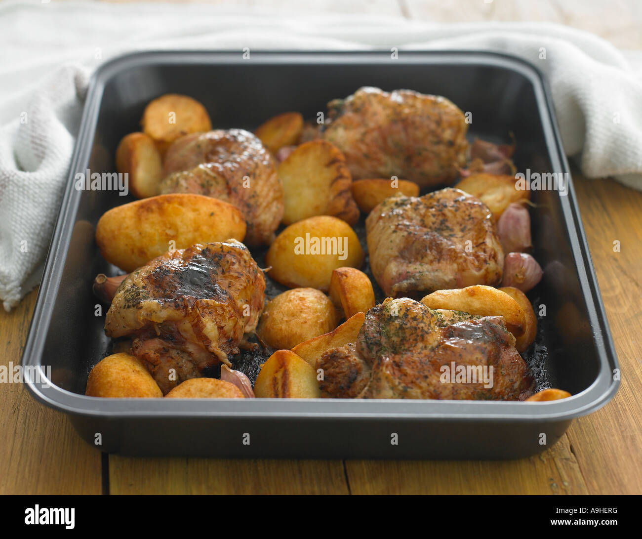 herb roast chicken in roasting tin Stock Photo Alamy