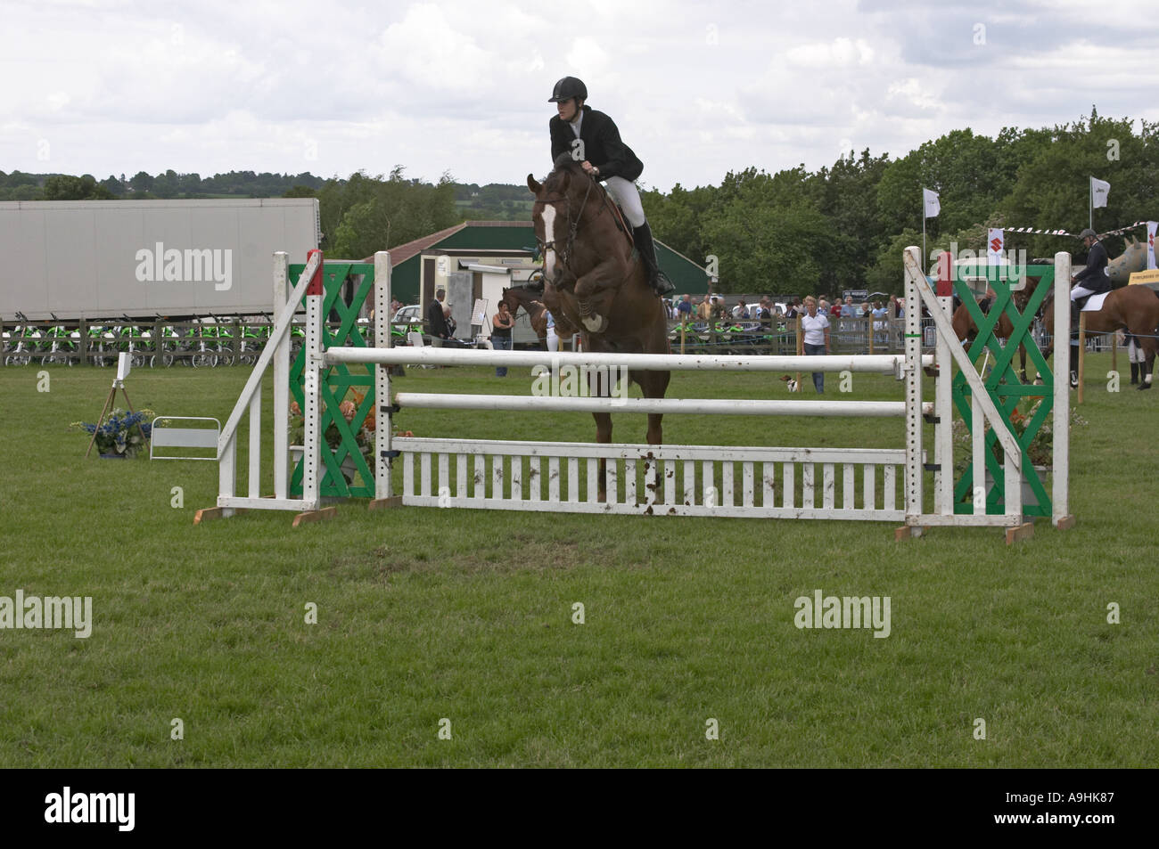 Woman on horse jumping a show jumping fence Stock Photo - Alamy