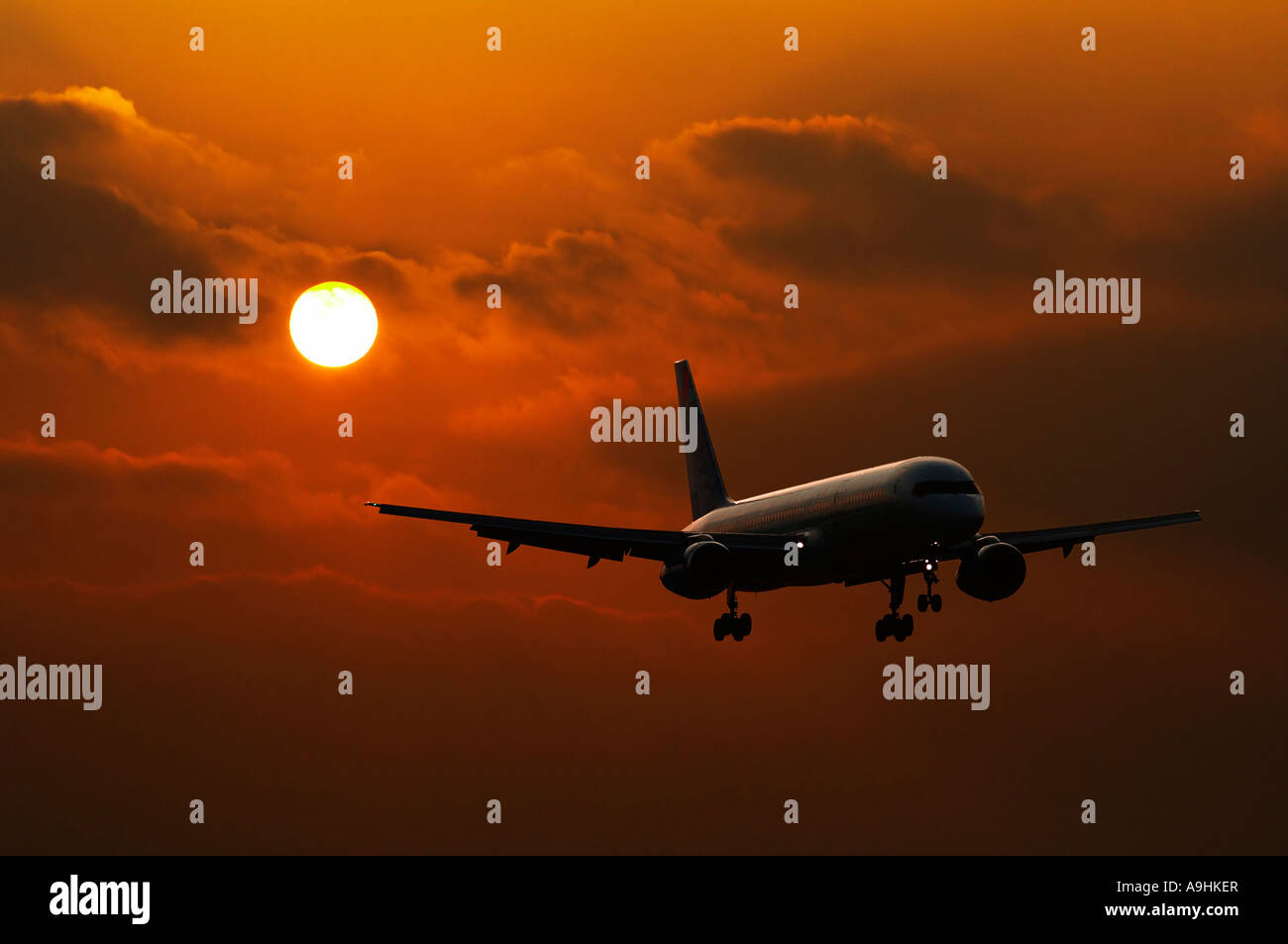 Airplane taking off into a sunset Stock Photo