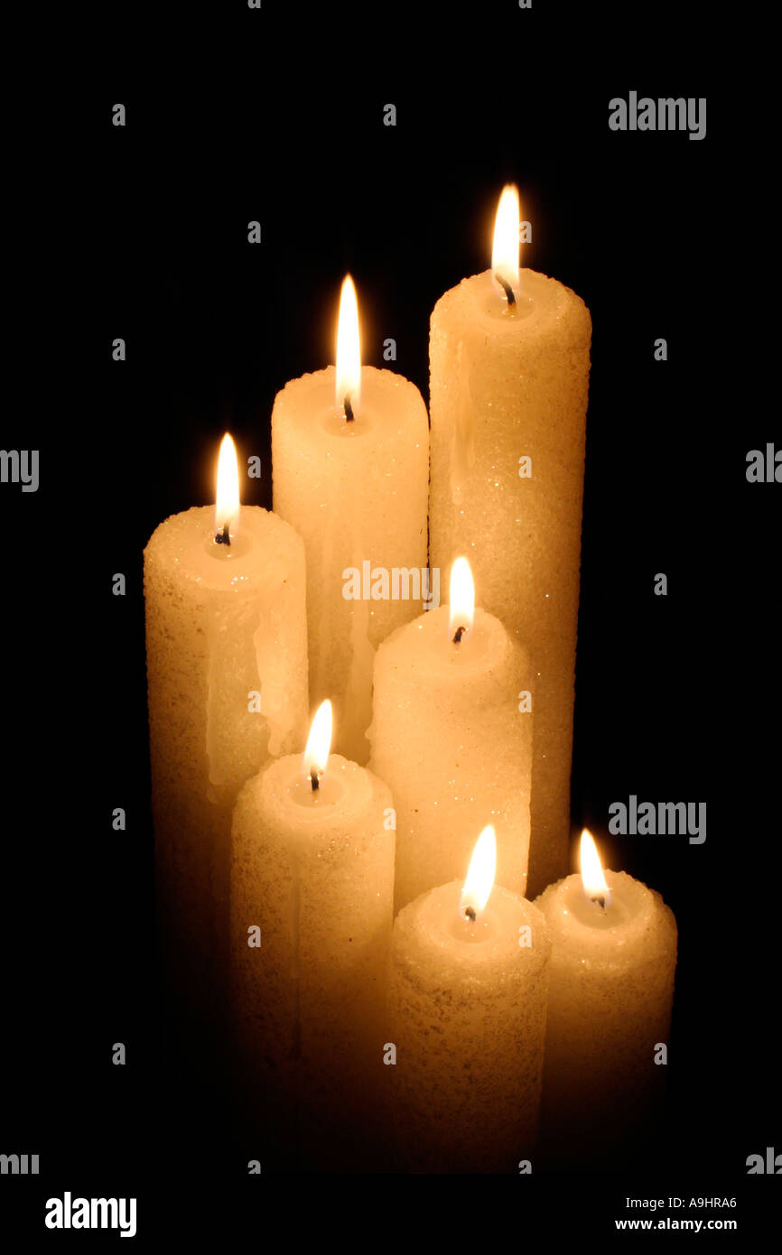 Group of lit candles of different sizes Stock Photo Alamy